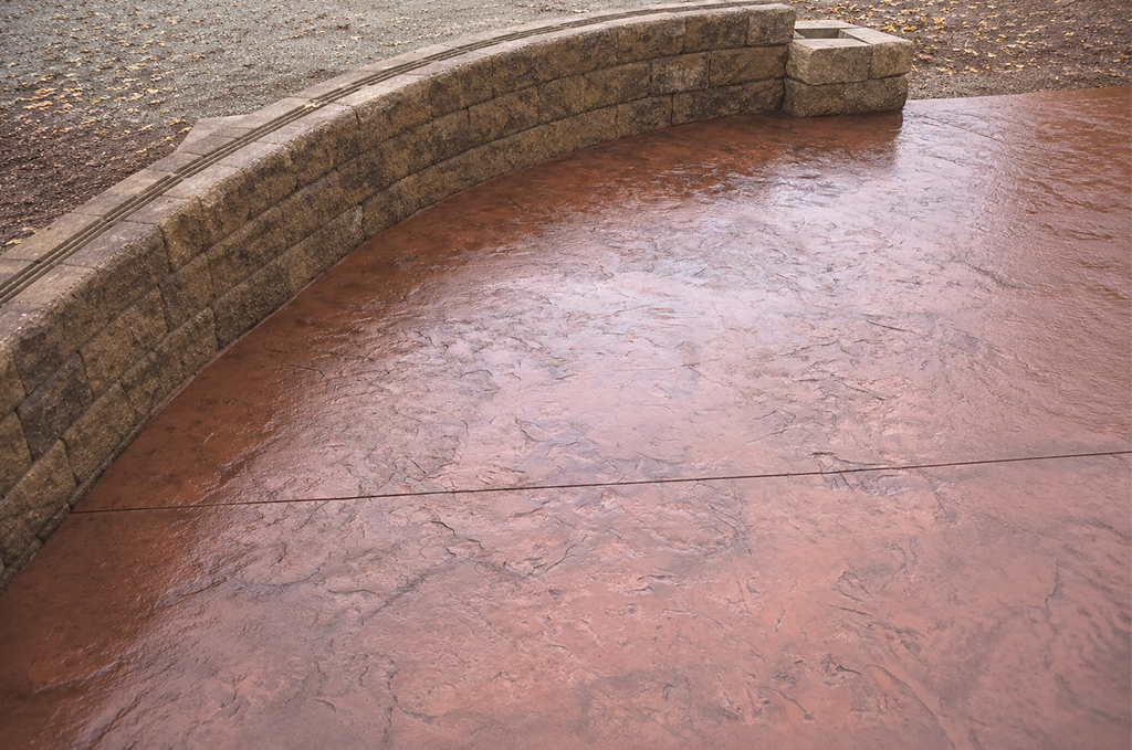 Finished concrete retaining wall and stamped patio project in Auburn Indiana by Marc Todd Concrete