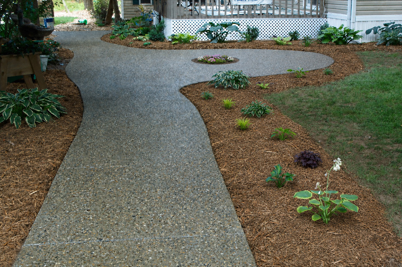 Exposed aggregate concrete pathway with planting area in Battle Creek, Michigan