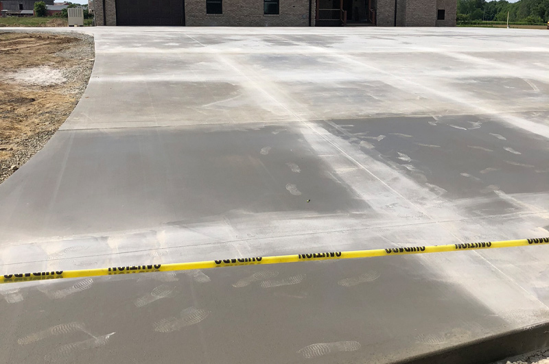 Large curved concrete driveway with control joints near Brighton, Indiana