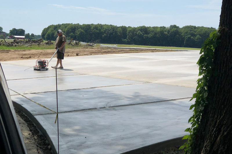 Cutting control joints in a new concrete driveway in Brighton, Indiana