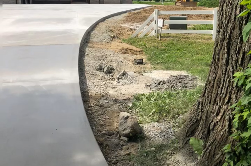 Finished curved concrete driveway with control joints near Brighton, Indiana
