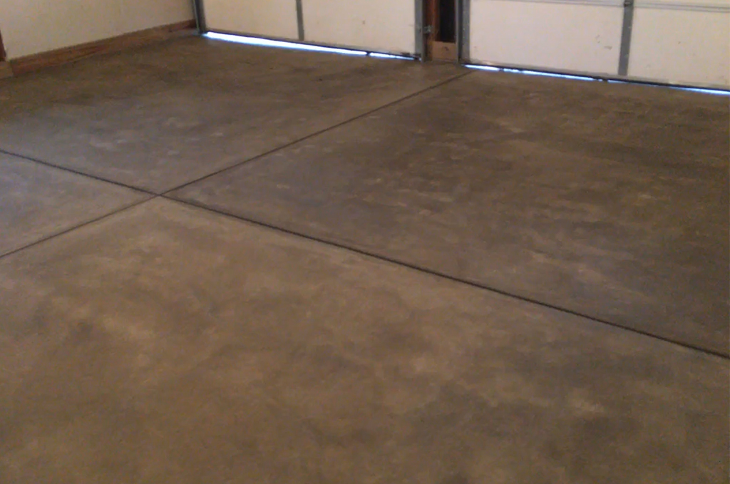 Colored concrete garage floor with tooled joints in Middlebury Indiana by Marc Todd Concrete