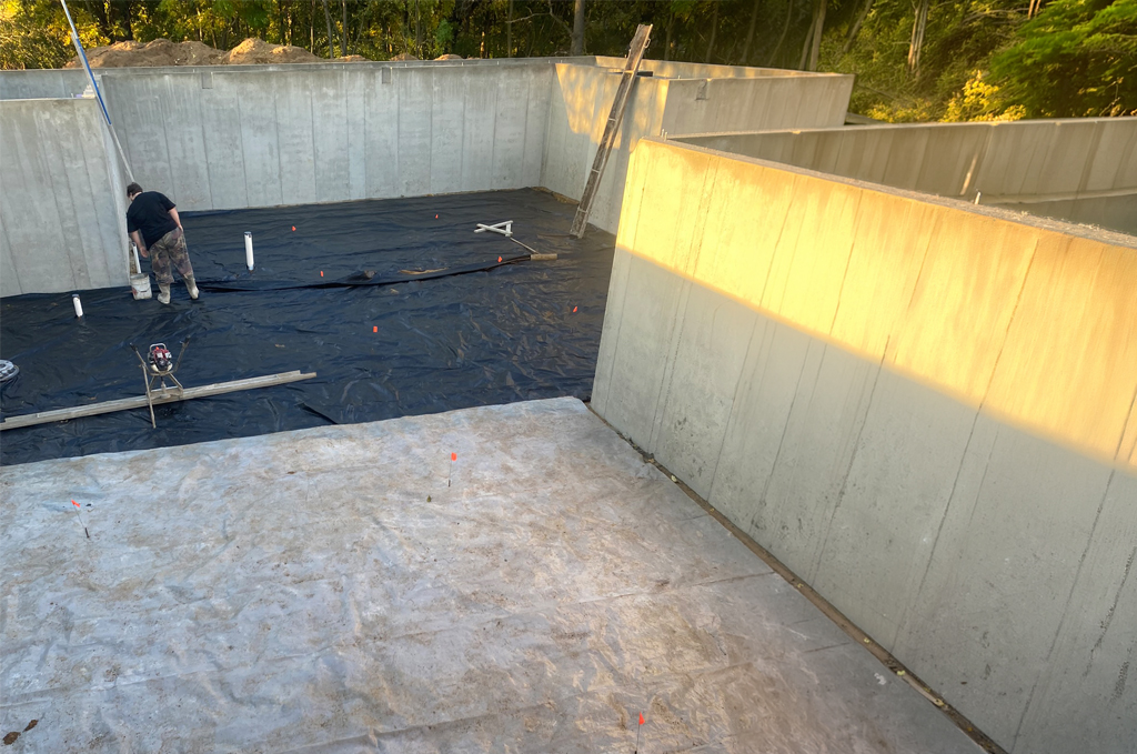 Concrete basement floor preparation with vapor barrier in Middlebury Indiana by Marc Todd Concrete