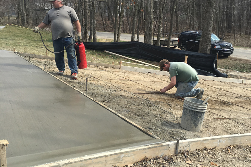 Curbed concrete edging on a steep driveway for water control in Millersburg, Indiana