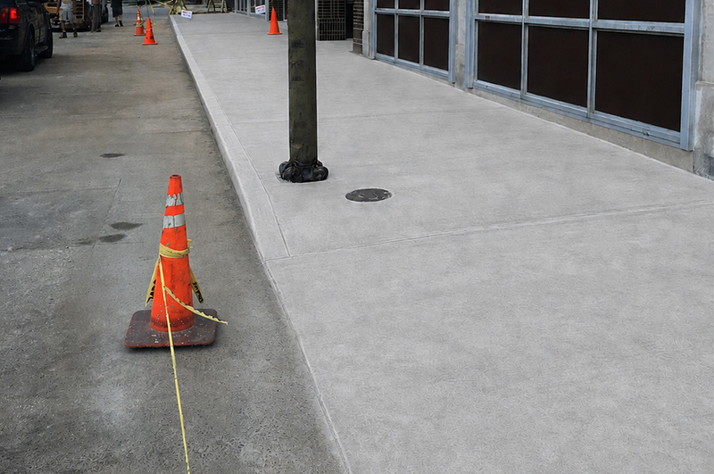 Light broom-finish commercial concrete sidewalk at a storefront in Niles Michigan
