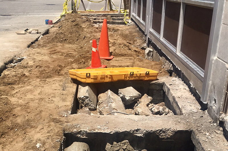 Excavation and preparation to fill abandoned coal chutes beneath a commercial sidewalk in Niles Michigan