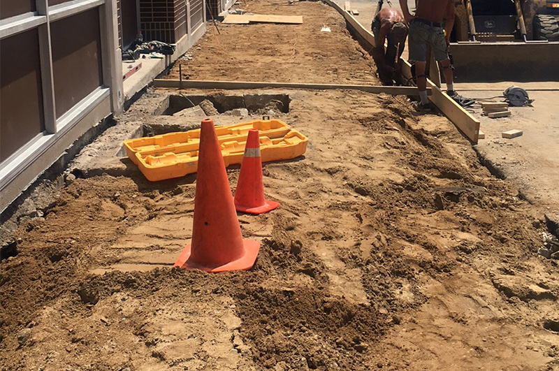 Commercial sidewalk and curb-and-gutter preparation along a storefront in Niles Michigan
