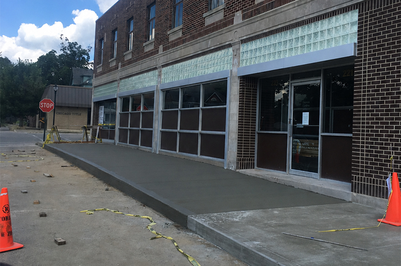 Completed concrete sidewalk, curb and gutter at a commercial storefront entrance in Niles Michigan