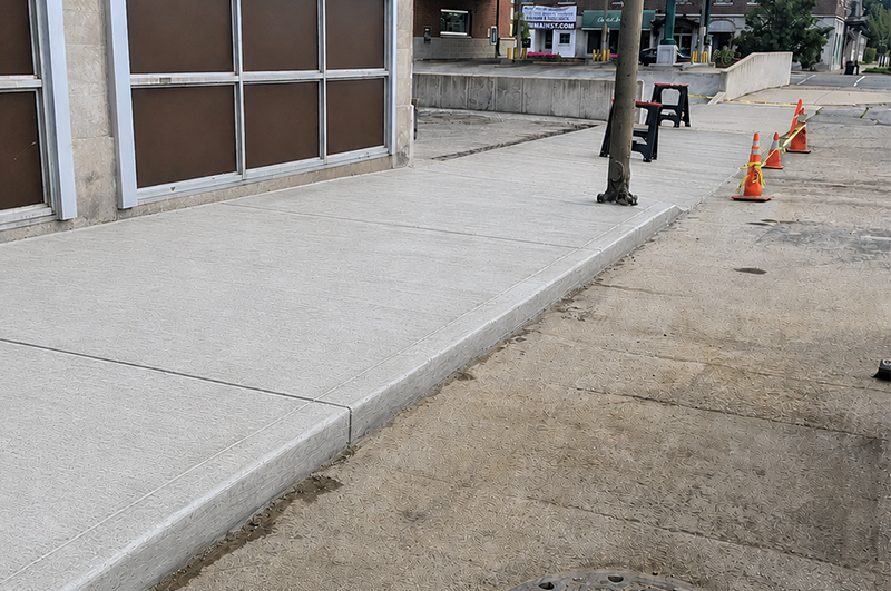 Commercial concrete sidewalk with curb and gutter along a storefront in Niles Michigan