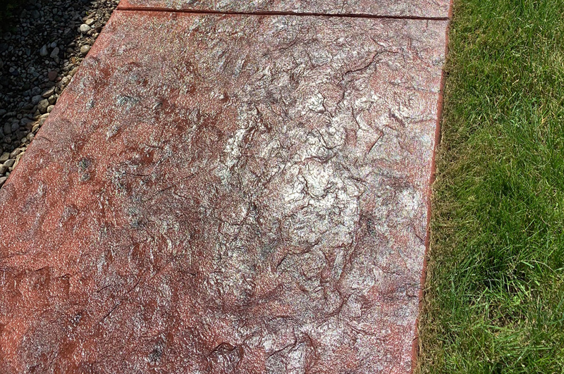 Close view of a curved colored and stamped concrete sidewalk in Vandalia, Michigan