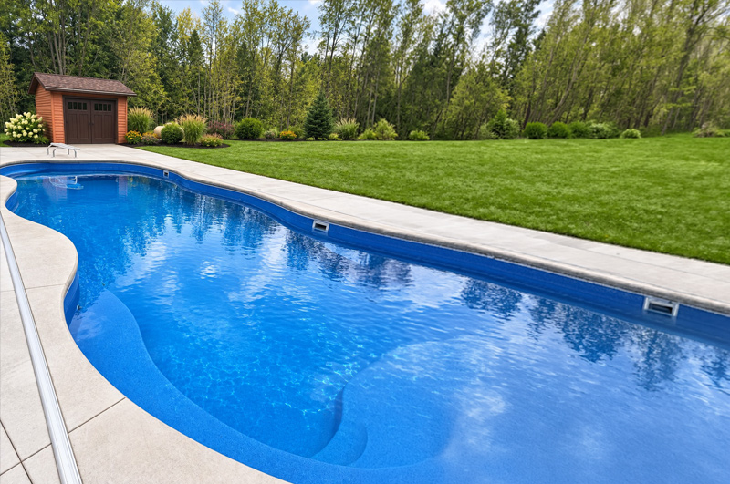 Concrete swimming pool surround and deck in Vicksburg, Michigan