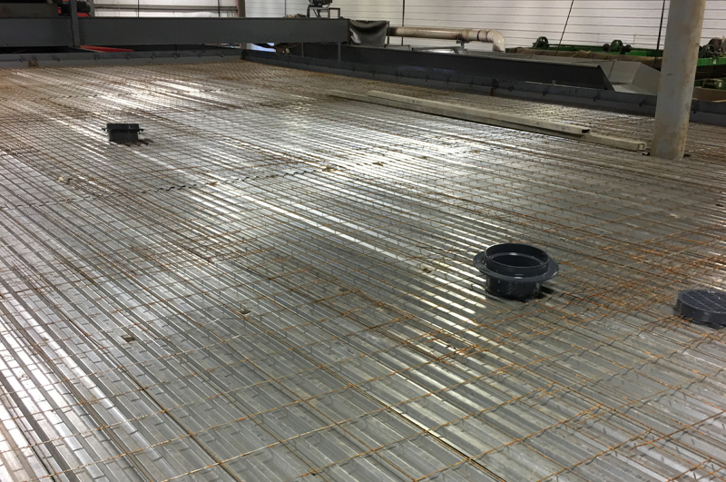 Concrete pump hose delivering lightweight concrete to the second-story commercial floor