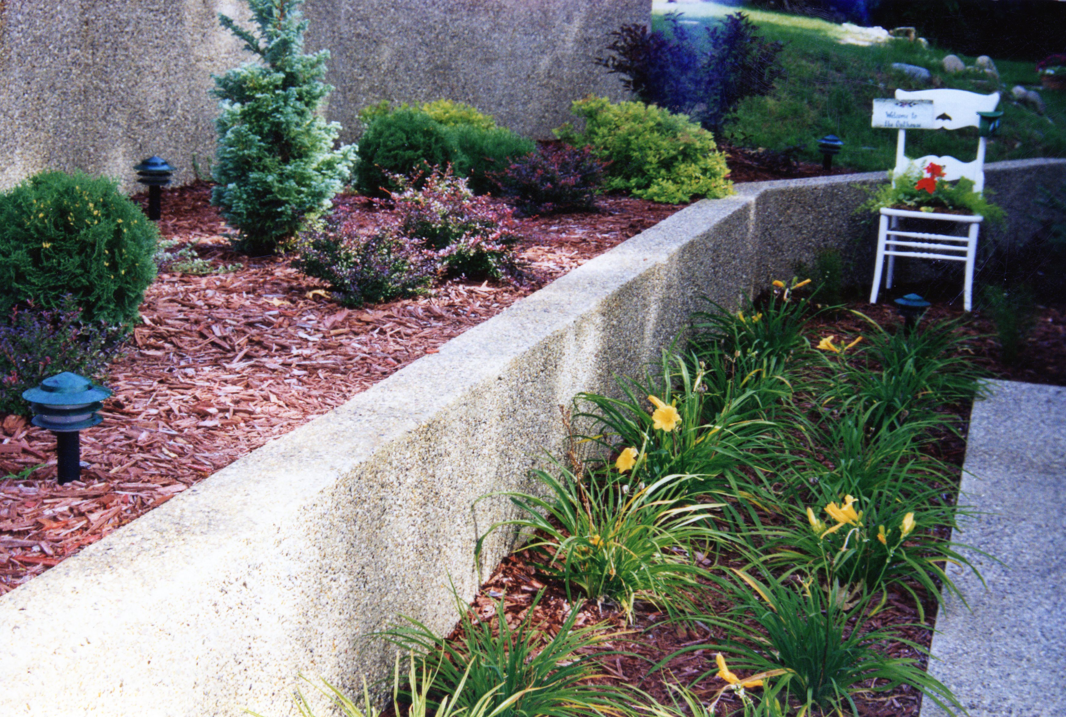 Custom concrete planting beds with exposed aggregate finish in Sturgis Michigan